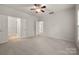 A spacious main bedroom offers lots of natural light, a ceiling fan, and plush carpet at 17513 Hawks View Dr, Fort Mill, SC 29707
