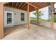 Spacious covered patio with concrete flooring and a door leading to the backyard at 17513 Hawks View Dr, Fort Mill, SC 29707