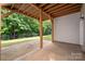 Covered patio with concrete flooring and wooden beams, offering a shady outdoor space at 17513 Hawks View Dr, Fort Mill, SC 29707