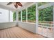 Screened-in porch featuring a wood ceiling, ceiling fan, wood flooring, and views of the wooded backyard at 17513 Hawks View Dr, Fort Mill, SC 29707