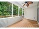 The screened-in porch has white walls, ceiling fan, and a view to the natural landscape at 17513 Hawks View Dr, Fort Mill, SC 29707
