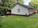 Exterior of home with siding, back patio, hot tub, and lush greenery surrounding the property is seen at 1920 Waldeck Ct, Mount Pleasant, NC 28124