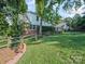 The backyard features lush green grass, a wooden fence, and partial view of the home's exterior at 2020 Dawnshire Dr, Gastonia, NC 28054