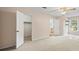Neutral bedroom with multiple doors, closet, and a large carpeted floor space at 2020 Dawnshire Dr, Gastonia, NC 28054