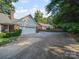 Long driveway leading to a two-car garage and the brick exterior of the home at 2020 Dawnshire Dr, Gastonia, NC 28054