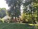 Charming brick home with mature trees and lush landscaping creating a serene and inviting curb appeal at 2020 Dawnshire Dr, Gastonia, NC 28054