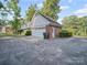 Two car garage with brick exterior, spacious driveway, and landscaping at 2020 Dawnshire Dr, Gastonia, NC 28054