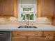 Bright kitchen sink with stainless steel faucet and a view to the outdoors at 2020 Dawnshire Dr, Gastonia, NC 28054