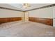 Spacious living room featuring carpeted floors and wood paneled walls at 2020 Dawnshire Dr, Gastonia, NC 28054