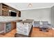 A basement bar area with stone accents, wooden countertop, wine rack, and modern sofa at 2275 Laurens Dr, Concord, NC 28027