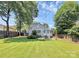 Well-maintained backyard with a patio, seating, lush lawn, and privacy fence at 2333 Greenland Ave, Charlotte, NC 28208