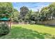 Spacious backyard with lush green grass and a wooden fence, providing privacy and space to play at 2333 Greenland Ave, Charlotte, NC 28208