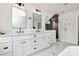 Modern bathroom featuring a glass shower, modern fixtures, double vanity, and marble tile at 2333 Greenland Ave, Charlotte, NC 28208