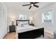 Cozy bedroom featuring a ceiling fan, windows with blinds, and a comfortable bed with nightstands at 2333 Greenland Ave, Charlotte, NC 28208