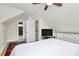 Bright bedroom features neutral walls, ceiling fan, and a view of a bathroom at 2333 Greenland Ave, Charlotte, NC 28208