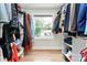 Walk-in closet with custom shelving and a window for natural light at 2333 Greenland Ave, Charlotte, NC 28208
