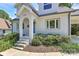 Inviting front entrance showcasing an arched entryway, brick detailing, and lush landscaping around the walkway at 2333 Greenland Ave, Charlotte, NC 28208