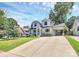 Charming two-story home featuring a well-manicured lawn, attached carport, and classic architectural details at 2333 Greenland Ave, Charlotte, NC 28208