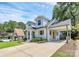 Charming two-story home with a painted brick exterior, dormers, and attached carport at 2333 Greenland Ave, Charlotte, NC 28208