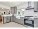 Modern kitchen with stainless steel appliances, gray cabinetry, and subway tile backsplash at 2333 Greenland Ave, Charlotte, NC 28208
