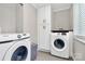Laundry room with modern washer and dryer and built in cabinets at 2333 Greenland Ave, Charlotte, NC 28208