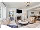 Bright living room featuring hardwood floors, fireplace, and open layout to dining area at 2333 Greenland Ave, Charlotte, NC 28208