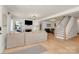Bright living room featuring hardwood floors, fireplace, and staircase to upper level at 2333 Greenland Ave, Charlotte, NC 28208