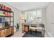Bright office space features a modern desk, chair, shelving, and plenty of natural light at 2333 Greenland Ave, Charlotte, NC 28208