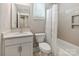 Well-lit bathroom with a decorative tile floor, and a white vanity, toilet, and tub with shower at 2969 Simpson Dr, Charlotte, NC 28205