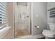 Updated bathroom showcasing a glass-enclosed shower with marble-look tile and a mosaic tile floor at 2969 Simpson Dr, Charlotte, NC 28205