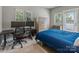 Comfortable bedroom with a desk, dresser, and two large windows offering natural light at 2969 Simpson Dr, Charlotte, NC 28205