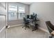 Comfortable bedroom with a large window, desk, rolling chair, and neutral carpeting at 2969 Simpson Dr, Charlotte, NC 28205