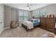 Cozy bedroom with soft carpet, ceiling fan, and two large windows for natural light at 2969 Simpson Dr, Charlotte, NC 28205
