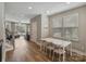 Bright dining area featuring a large dining table, chairs, and hardwood floors at 2969 Simpson Dr, Charlotte, NC 28205