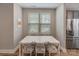 Bright dining area featuring a white table, chairs, and hardwood floors at 2969 Simpson Dr, Charlotte, NC 28205