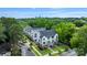 Beautiful townhomes with modern gray and white exteriors nestled among lush trees and landscaping with Charlotte skyline in the background at 2969 Simpson Dr, Charlotte, NC 28205
