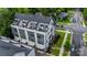View of modern townhomes featuring rooftop balconies, gray siding, meticulous landscaping, and inviting curb appeal at 2969 Simpson Dr, Charlotte, NC 28205
