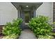 Inviting front door framed by lush greenery, providing a warm welcome to this charming townhome at 2969 Simpson Dr, Charlotte, NC 28205