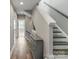 Entryway with stairs, hardwood floors, and a decorative cabinet at 2969 Simpson Dr, Charlotte, NC 28205