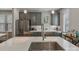 Kitchen with stainless steel appliances, grey cabinets, island, and herringbone backsplash at 2969 Simpson Dr, Charlotte, NC 28205