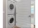 Modern laundry room with stacked washer and dryer, and plenty of natural light at 2969 Simpson Dr, Charlotte, NC 28205