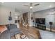 Inviting living room featuring hardwood floors, a ceiling fan, stylish furniture, and a decorative mural at 2969 Simpson Dr, Charlotte, NC 28205