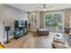 Bright living room with hardwood floors, a TV, blossom mural, and access to a balcony at 2969 Simpson Dr, Charlotte, NC 28205