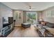 Bright living room featuring hardwood floors, comfortable seating, and sliding doors at 2969 Simpson Dr, Charlotte, NC 28205