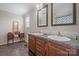 Bathroom featuring a double vanity with dark wood cabinets and dual mirrors at 308 Laurel Ridge Dr, Lincolnton, NC 28092