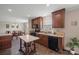Traditional kitchen featuring wooden cabinets, black appliances, tile floors, and a kitchen island at 308 Laurel Ridge Dr, Lincolnton, NC 28092