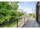 Spacious balcony with modern railings offering views of the building and surrounding lush greenery at 327 S Turner Ave, Charlotte, NC 28208