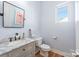 Cozy bathroom with a marble vanity top, modern fixtures, and a flamingo-themed art piece at 327 S Turner Ave, Charlotte, NC 28208