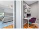 Spacious bedroom featuring a bed, wood floors, and walk-in closet/office space with a desk at 327 S Turner Ave, Charlotte, NC 28208