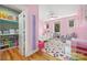 Pink bedroom with a ceiling fan, hardwood floors, closet and natural light from multiple windows at 327 S Turner Ave, Charlotte, NC 28208
